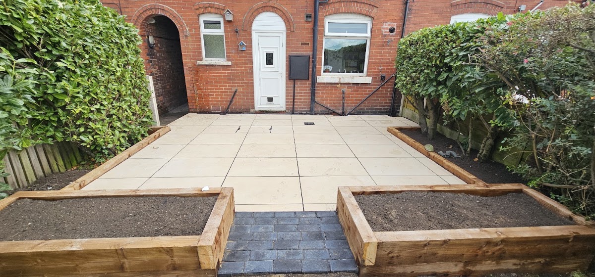 Cream porcelain flagged front garden with new timber sleeper raised beds